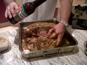 pour Salsa Lizano into the holes of the pork leg pour Salsa Lizano into the holes of the pork leg
