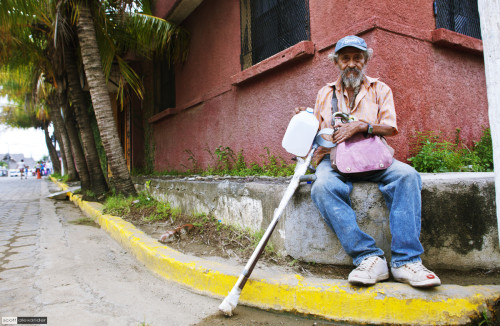 A friendly elderly man, relaxing for a few.