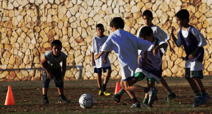 Israeli and Palestinian boys playing football, image by Football 4 Peace