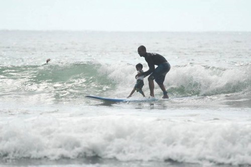 Father and son surfing in Esterillos