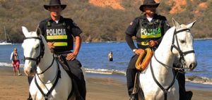 Mounted police officers guard a beach in Costa Rica.