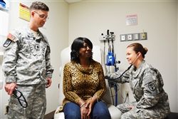Army Maj. Marielos Vega listens to Sherry Moore’s heart while Army Lt. Col. (Dr.) James Watts looks on in the cardiology department at Brooke Army Medical Center in San Antonio, March 17, 2015. U.S. Army photo by Robert T. Shields  