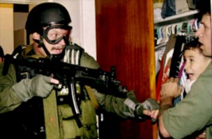 Unidentified U.S. federal agent during the seizure of Elián González from his uncle's residence on April 22, 2000. Pulitzer Prize for Breaking News Photography. Wikimedia Commons Fair Use