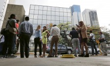 Members of the media stand outside the Mossack Fonseca law firm office in Panama City April 12, 2016. REUTERS/Carlos Jasso